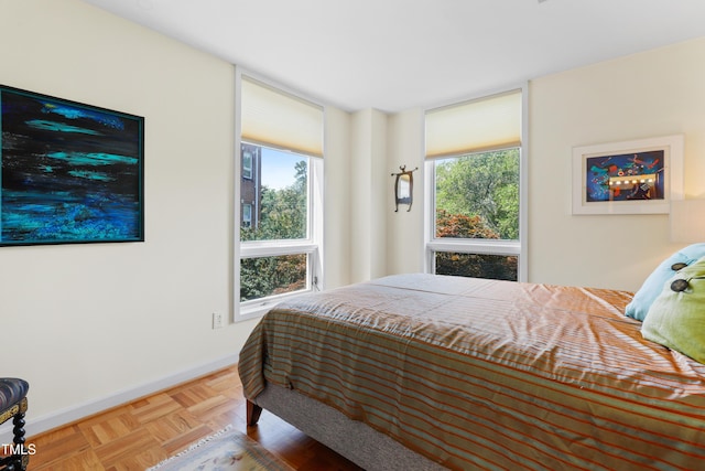 bedroom with multiple windows and baseboards