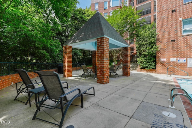 view of patio / terrace featuring fence and a gazebo