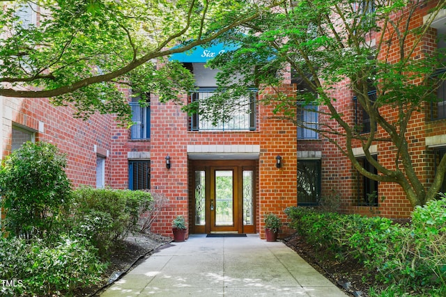 property entrance featuring brick siding