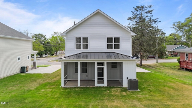 412 W Stallings St, Clayton, NC 27520 - rear view of house with a sunroom, a lawn, a standing seam roof, and cooling unit