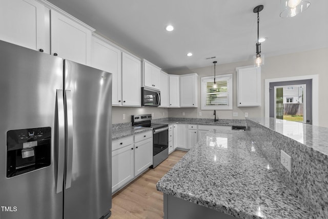 412 W Stallings St, Clayton, NC 27520 - kitchen with white cabinetry, appliances with stainless steel finishes, light wood-style floors, and recessed lighting