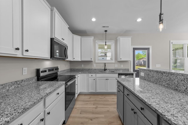 412 W Stallings St, Clayton, NC 27520 - kitchen featuring recessed lighting, a sink, white cabinetry, stainless steel range with electric cooktop, and light wood-style floors