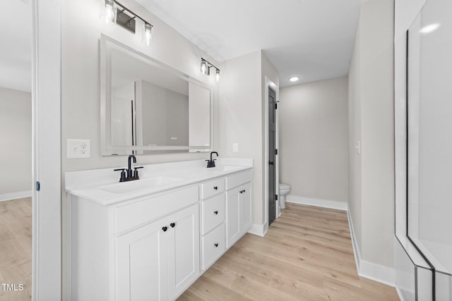 412 W Stallings St, Clayton, NC 27520 - full bathroom featuring toilet, a sink, and wood finished floors