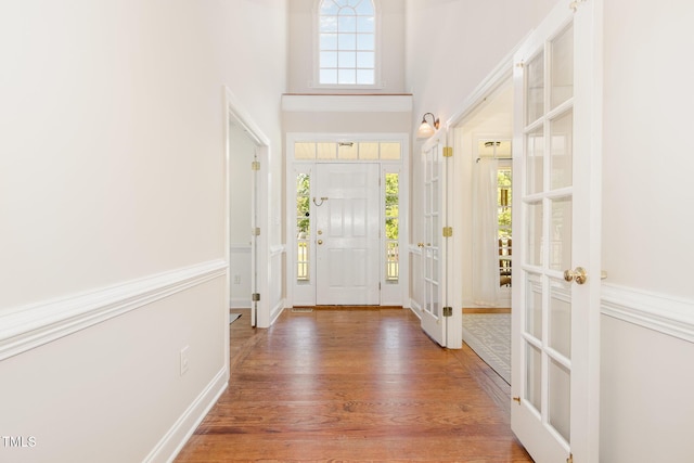 101 Rainbow Dr, Carrboro, NC 27510 - entryway with wood finished floors, a towering ceiling, french doors, and baseboards