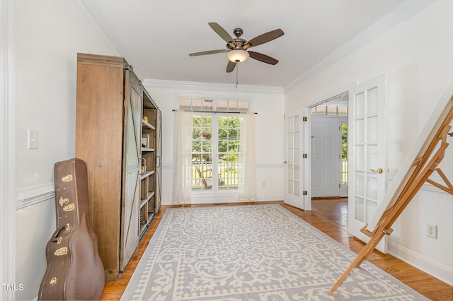 101 Rainbow Dr, Carrboro, NC 27510 - foyer featuring a ceiling fan, crown molding, light wood-style flooring, baseboards, and french doors