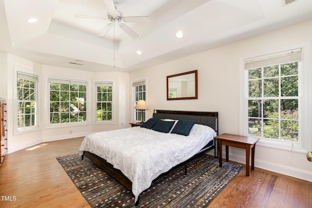 101 Rainbow Dr, Carrboro, NC 27510 - bedroom with a raised ceiling, baseboards, light wood finished floors, multiple windows, and recessed lighting
