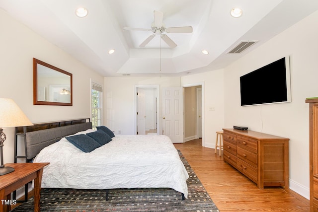 101 Rainbow Dr, Carrboro, NC 27510 - bedroom with a tray ceiling, light wood finished floors, recessed lighting, baseboards, and a ceiling fan