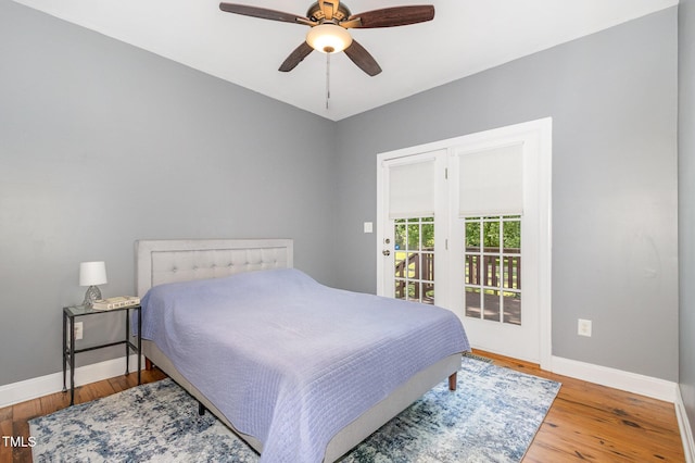 101 Rainbow Dr, Carrboro, NC 27510 - bedroom featuring baseboards, wood finished floors, access to outside, and ceiling fan