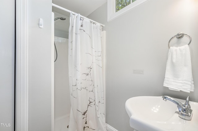 101 Rainbow Dr, Carrboro, NC 27510 - full bathroom featuring a sink, a shower with shower curtain, and baseboards