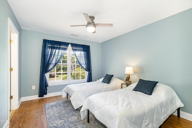 101 Rainbow Dr, Carrboro, NC 27510 - bedroom featuring baseboards, wood finished floors, and ceiling fan