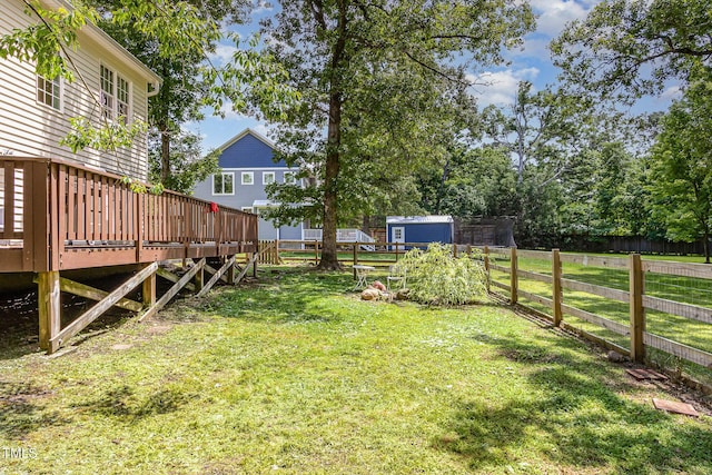 101 Rainbow Dr, Carrboro, NC 27510 - view of yard featuring a wooden deck and an outbuilding
