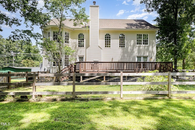 101 Rainbow Dr, Carrboro, NC 27510 - back of house featuring a wooden deck, a chimney, and roof with shingles