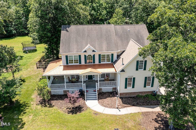 101 Rainbow Dr, Carrboro, NC 27510 - view of front facade with a trampoline, a front yard, a porch, stairway, and roof with shingles
