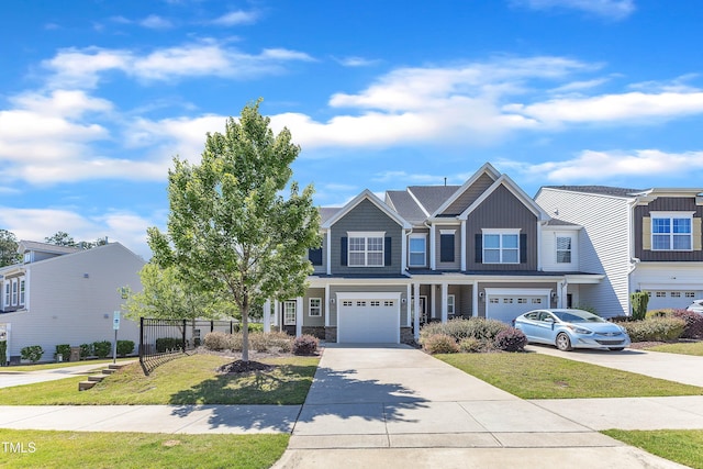 view of front facade with an attached garage, driveway, and stone siding