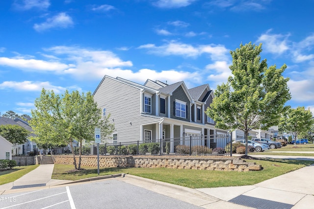 view of front facade with a fenced front yard, a residential view, and uncovered parking