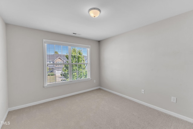 empty room with carpet flooring and baseboards
