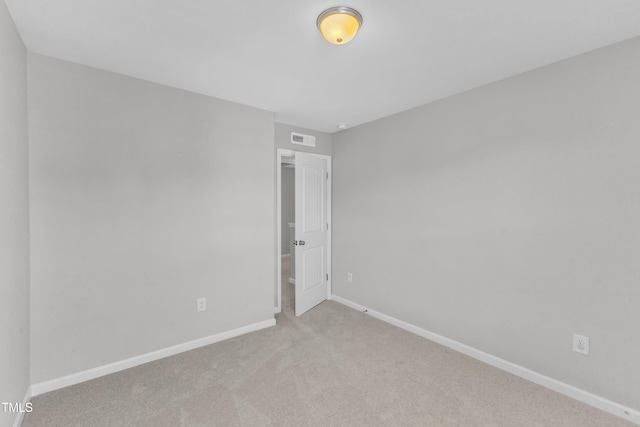 empty room with baseboards and light colored carpet