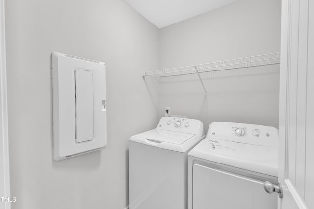 clothes washing area with separate washer and dryer