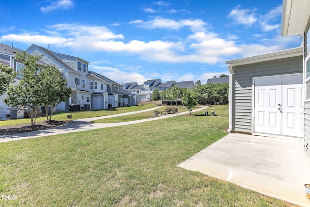 view of green lawn with a residential view