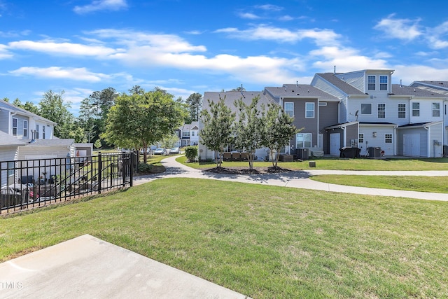 view of yard with a residential view and central AC