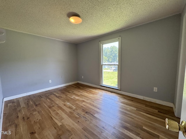 111 Marshay Meadow Rd, Youngsville, NC 27596 - empty room featuring a textured ceiling, wood finished floors, and crown molding