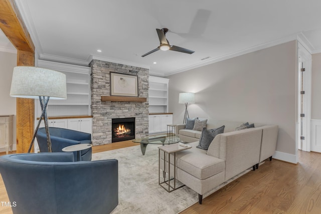living room with crown molding, wood finished floors, a ceiling fan, a fireplace, and recessed lighting