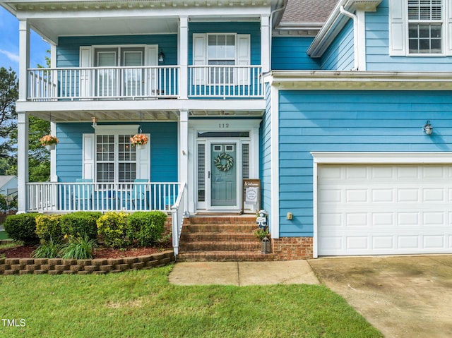 112 Nelson Ln, Clayton, NC 27527 - view of front of property featuring a balcony, an attached garage, covered porch, driveway, and a shingled roof