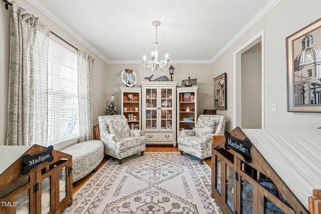 112 Nelson Ln, Clayton, NC 27527 - living area featuring a chandelier, wood finished floors, and crown molding