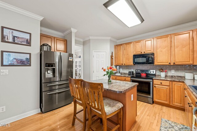 112 Nelson Ln, Clayton, NC 27527 - kitchen featuring appliances with stainless steel finishes, ornamental molding, light wood-type flooring, and decorative backsplash