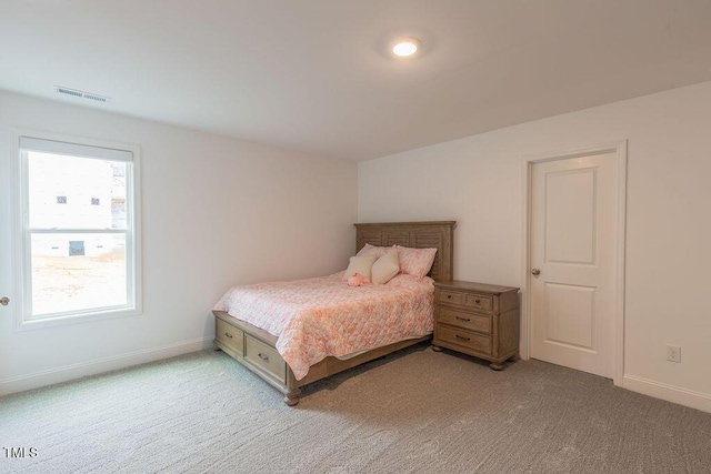 bedroom featuring baseboards, visible vents, and light colored carpet