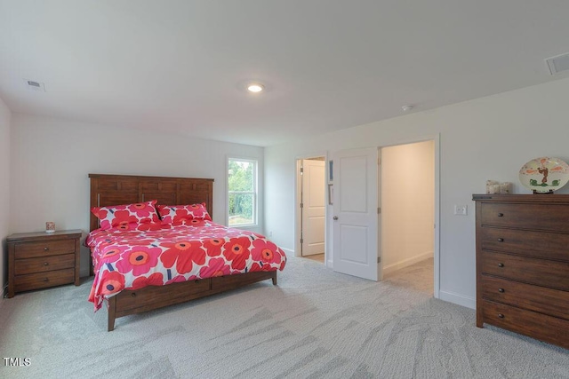 carpeted bedroom featuring baseboards and visible vents