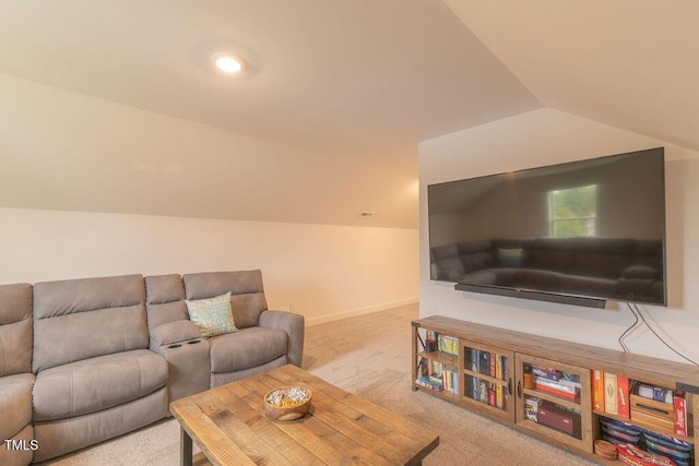 carpeted living room with lofted ceiling and baseboards