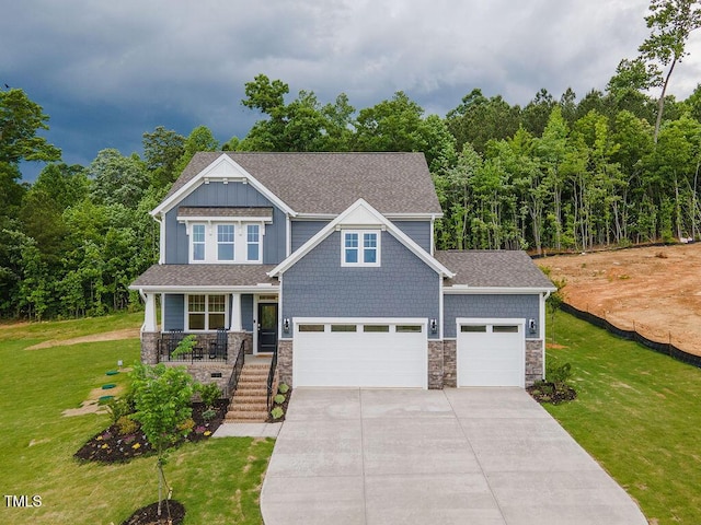 craftsman-style house with a porch, a front lawn, stone siding, and driveway