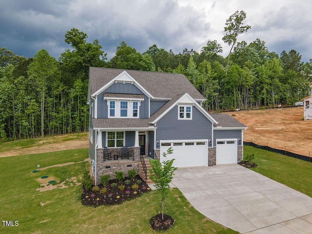 craftsman house with concrete driveway, stone siding, a porch, and a front lawn