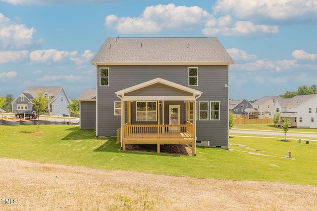 rear view of house with a yard, fence, a residential view, and crawl space