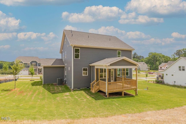 rear view of house with a sunroom, crawl space, a lawn, central AC unit, and roof with shingles