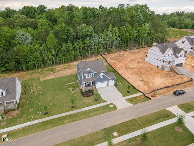 birds eye view of property with a wooded view