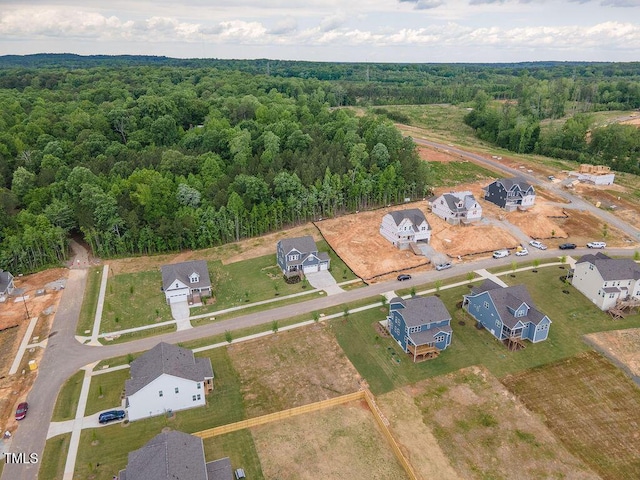 birds eye view of property featuring a view of trees and a residential view