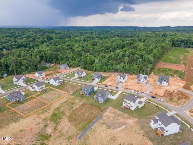 aerial view featuring a forest view and a residential view