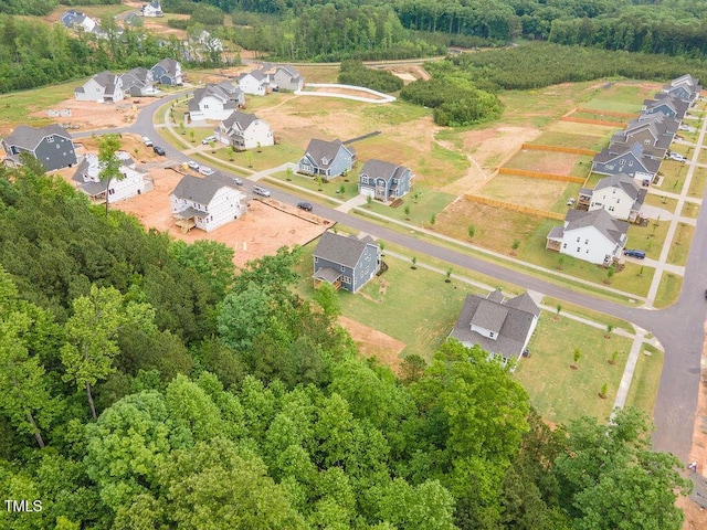 birds eye view of property with a forest view and a residential view