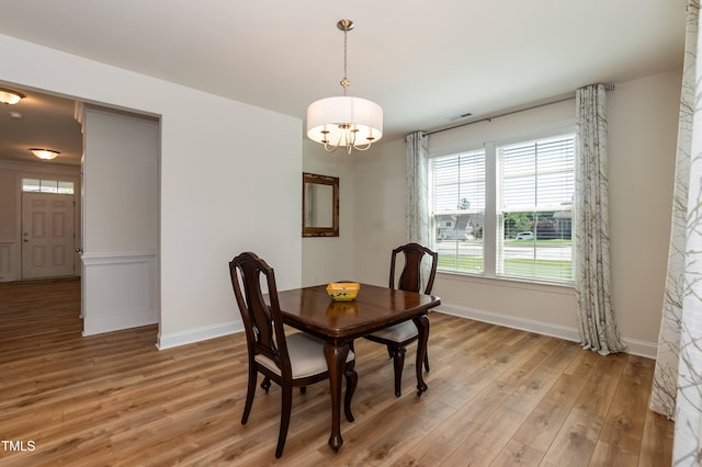 3536 Greenville Loop Rd, Wake Forest, NC 27587 - dining area with a chandelier, light wood-type flooring, and baseboards