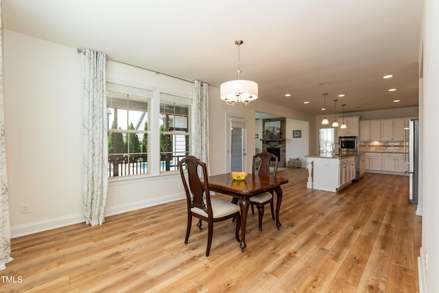 3536 Greenville Loop Rd, Wake Forest, NC 27587 - dining space featuring light wood-style flooring, a chandelier, recessed lighting, and baseboards
