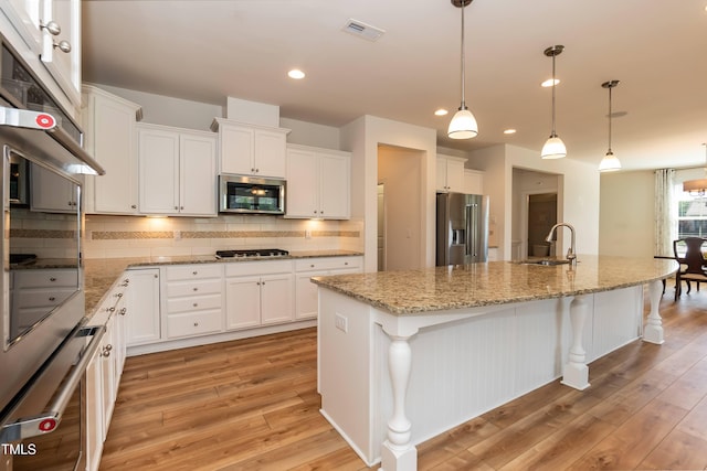 3536 Greenville Loop Rd, Wake Forest, NC 27587 - kitchen featuring stainless steel appliances, a sink, light wood-type flooring, white cabinets, and recessed lighting