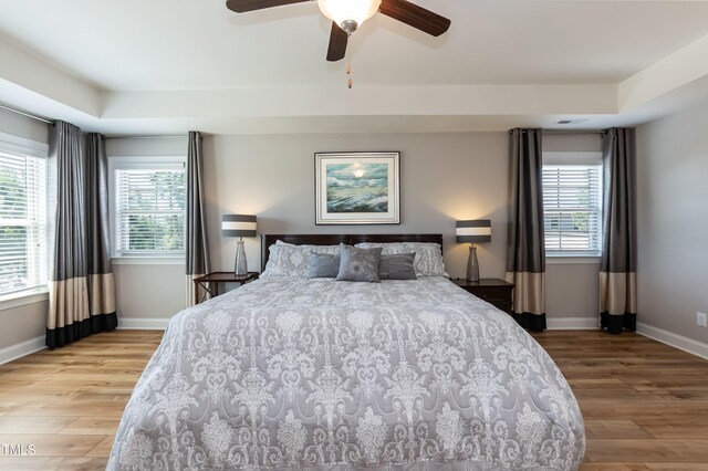 3536 Greenville Loop Rd, Wake Forest, NC 27587 - bedroom with light wood-type flooring, multiple windows, and baseboards