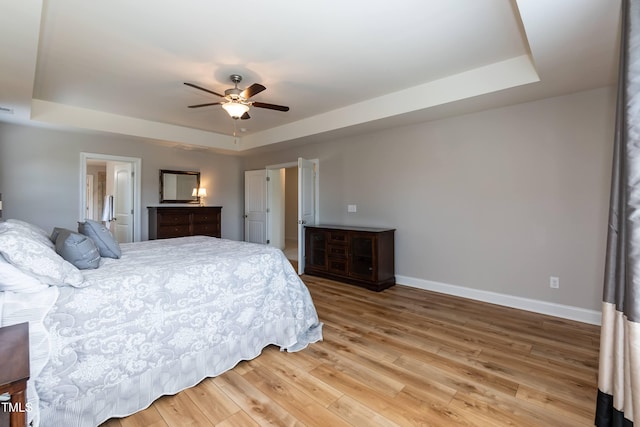 3536 Greenville Loop Rd, Wake Forest, NC 27587 - bedroom with a tray ceiling, baseboards, light wood-style floors, and ceiling fan