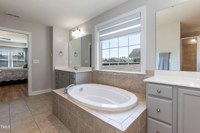 3536 Greenville Loop Rd, Wake Forest, NC 27587 - bathroom with a garden tub, vanity, connected bathroom, a tile shower, and baseboards