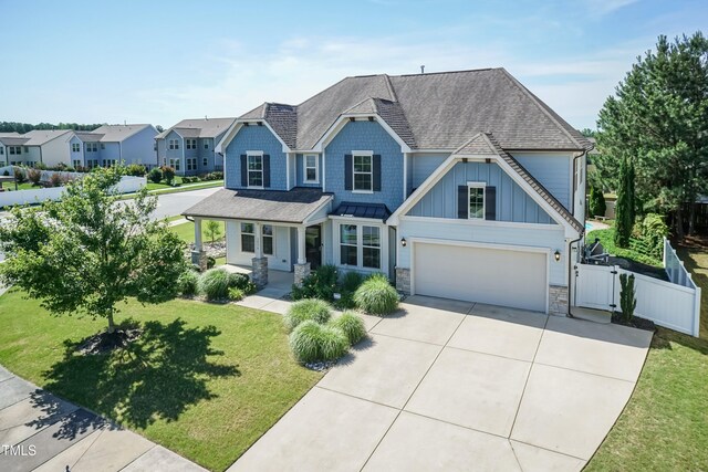 3536 Greenville Loop Rd, Wake Forest, NC 27587 - craftsman inspired home featuring concrete driveway, a shingled roof, stone siding, and a gate