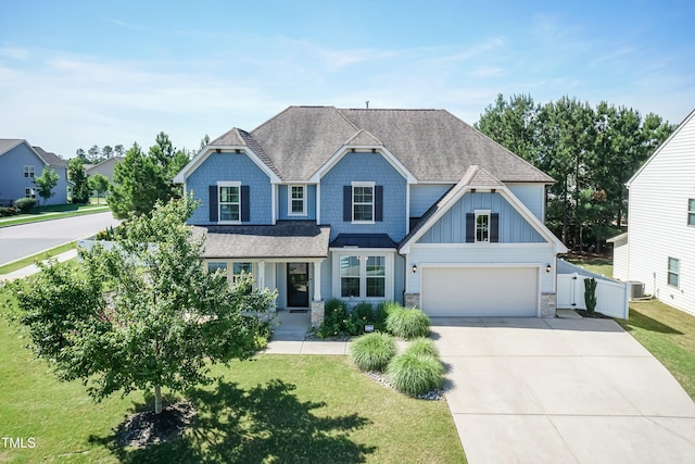 3536 Greenville Loop Rd, Wake Forest, NC 27587 - craftsman house with driveway, a shingled roof, stone siding, board and batten siding, and central AC