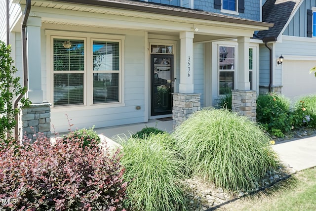 3536 Greenville Loop Rd, Wake Forest, NC 27587 - entrance to property featuring covered porch, stone siding, and roof with shingles