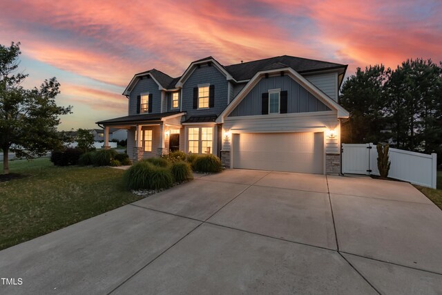 3536 Greenville Loop Rd, Wake Forest, NC 27587 - view of front of property with a gate, driveway, stone siding, covered porch, and board and batten siding